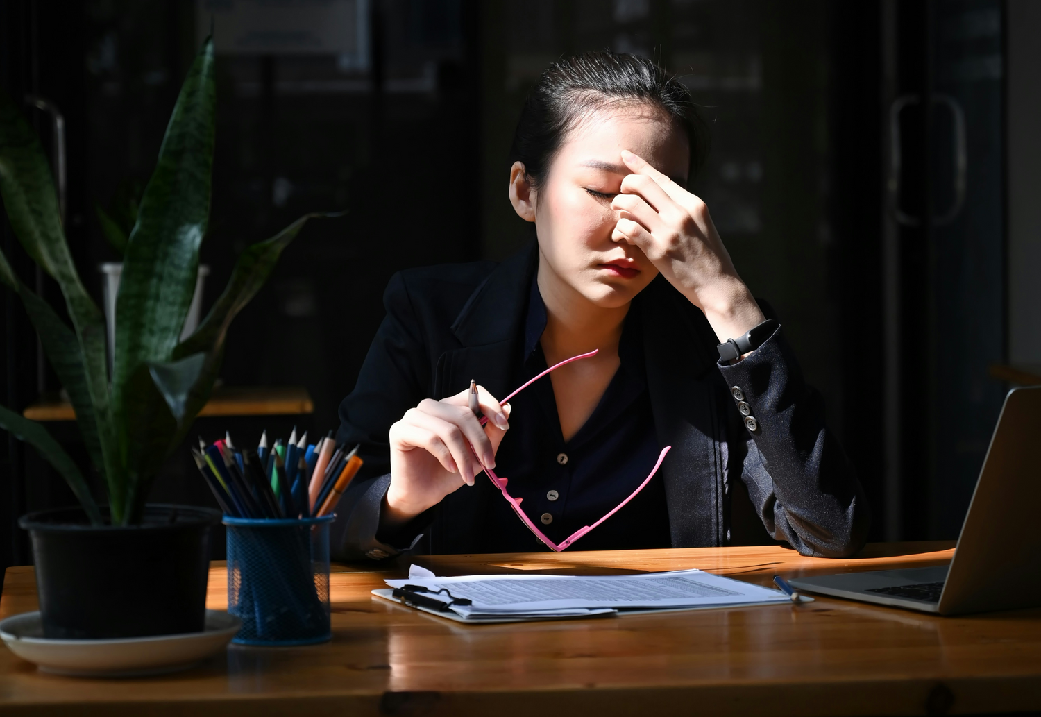 Image of fatigued women holding her head